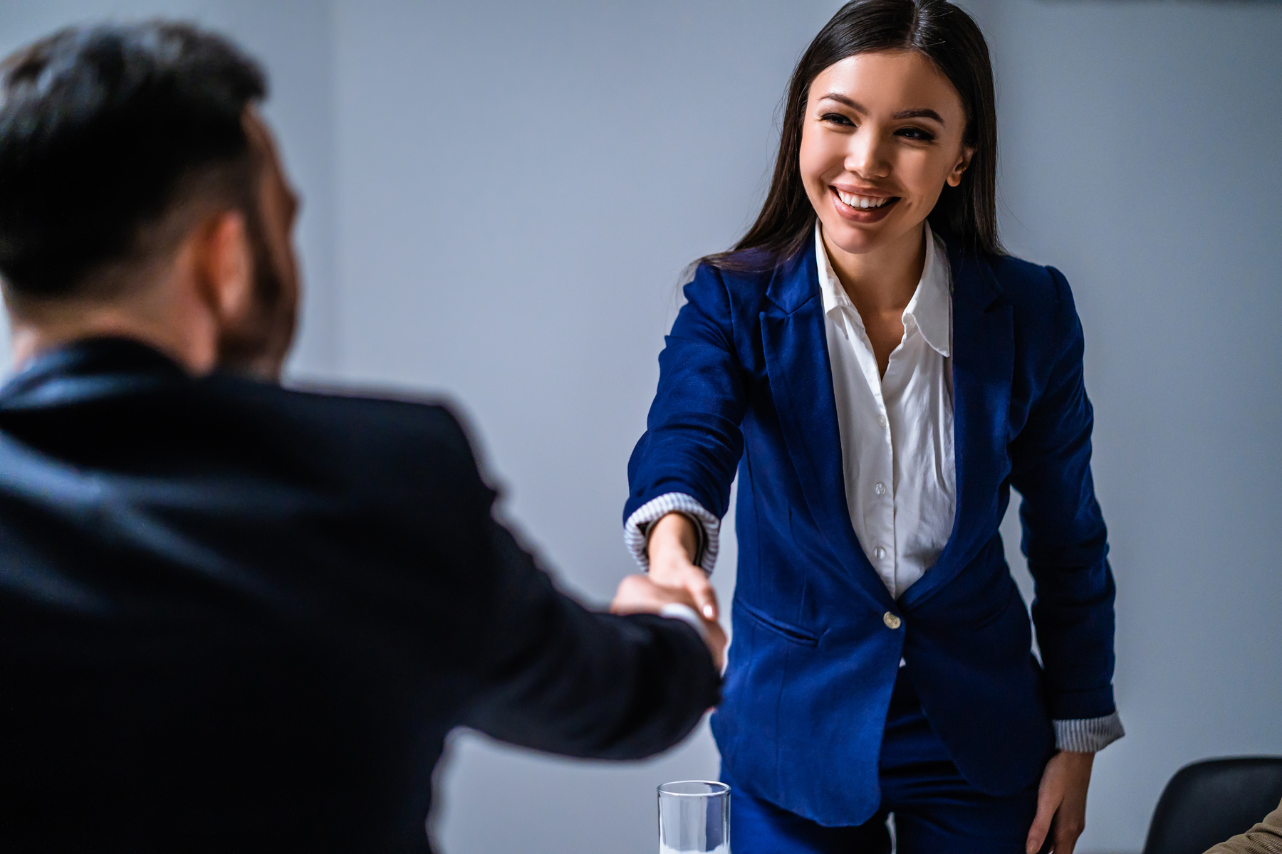 The business woman and man handshaking
